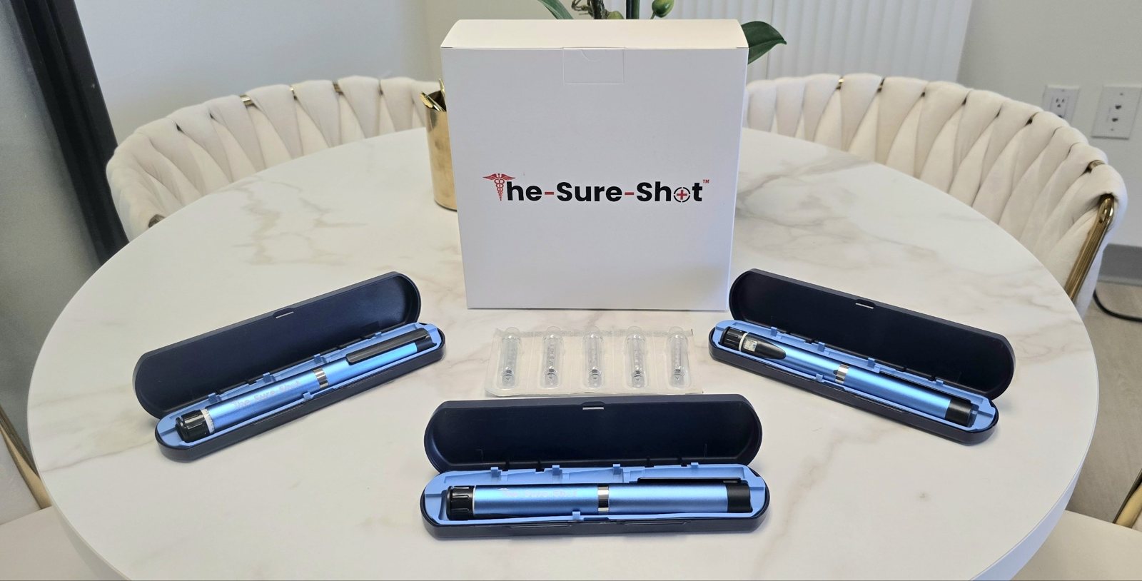 The Sure-Shot pen kit: three click-dose pens in cases, sealed ampules and the Sure-Shot box