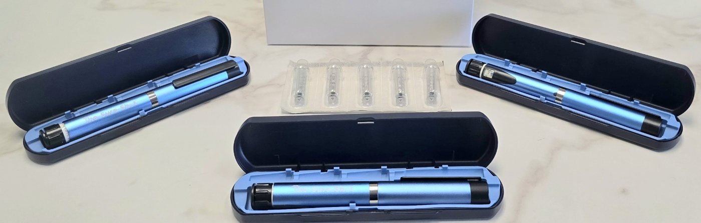 Three Sure-Shot pens in cases with a strip of sealed ampules